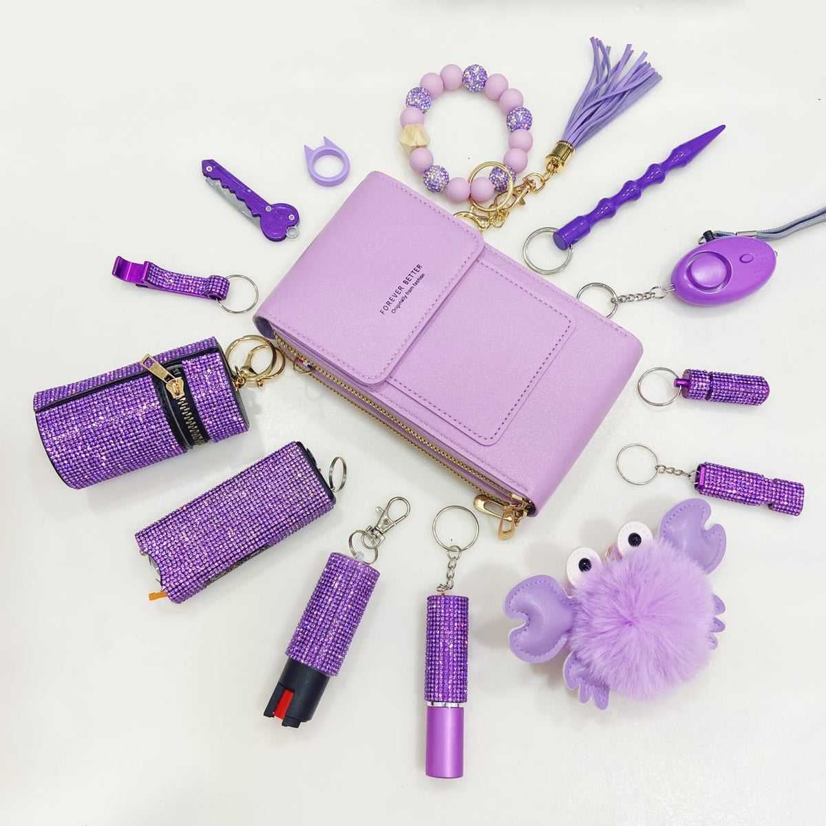 Purple safety keychains, alarms, and stylish self-defense tools with glittery accents for women