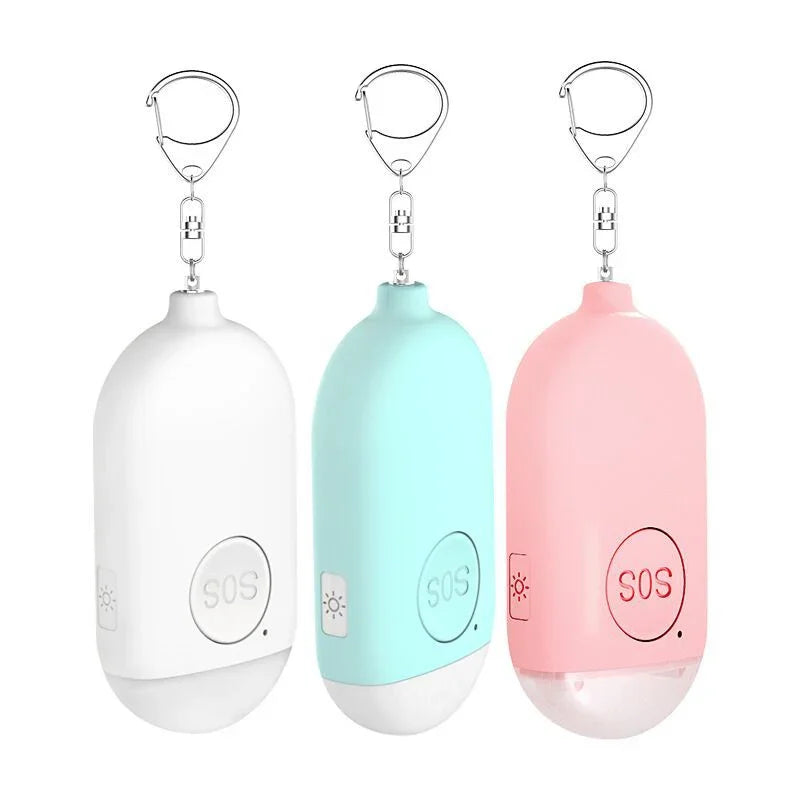 Three emergency SOS keychains in white, light blue, and pink on a white background.