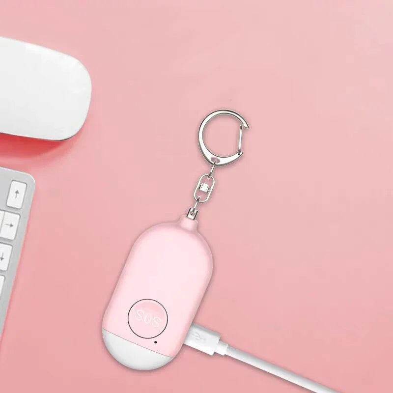 Pink USB device with keychain on a pink background